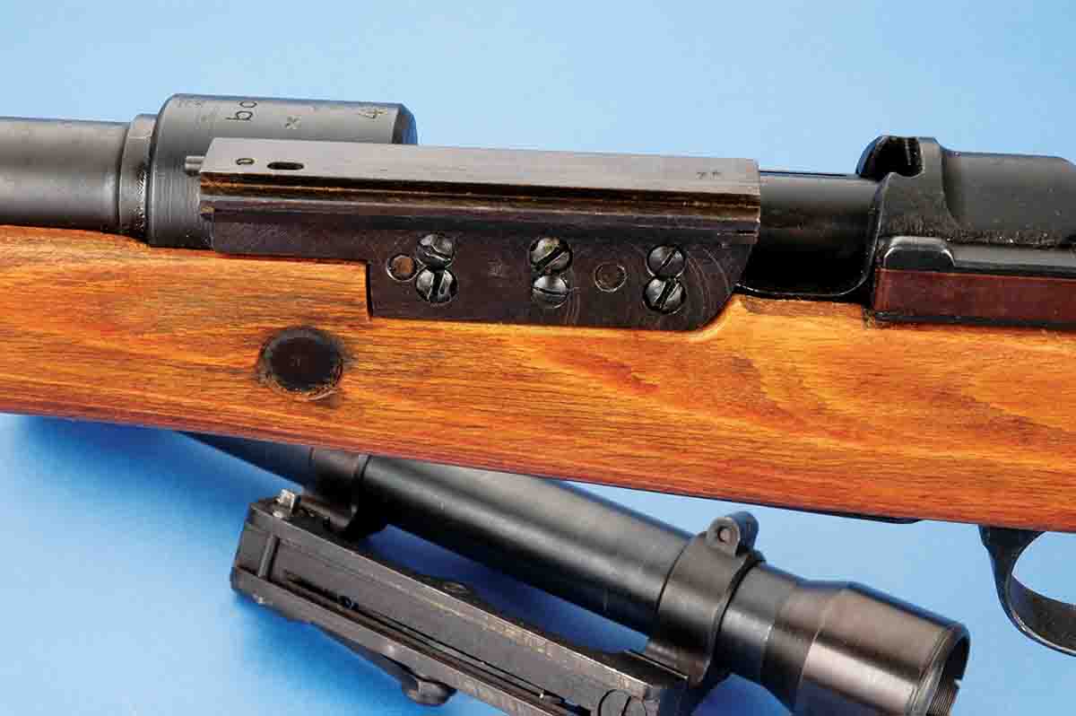 This is the quick-detachable, dovetailed rail-mounting system of a German long side-rail mount.